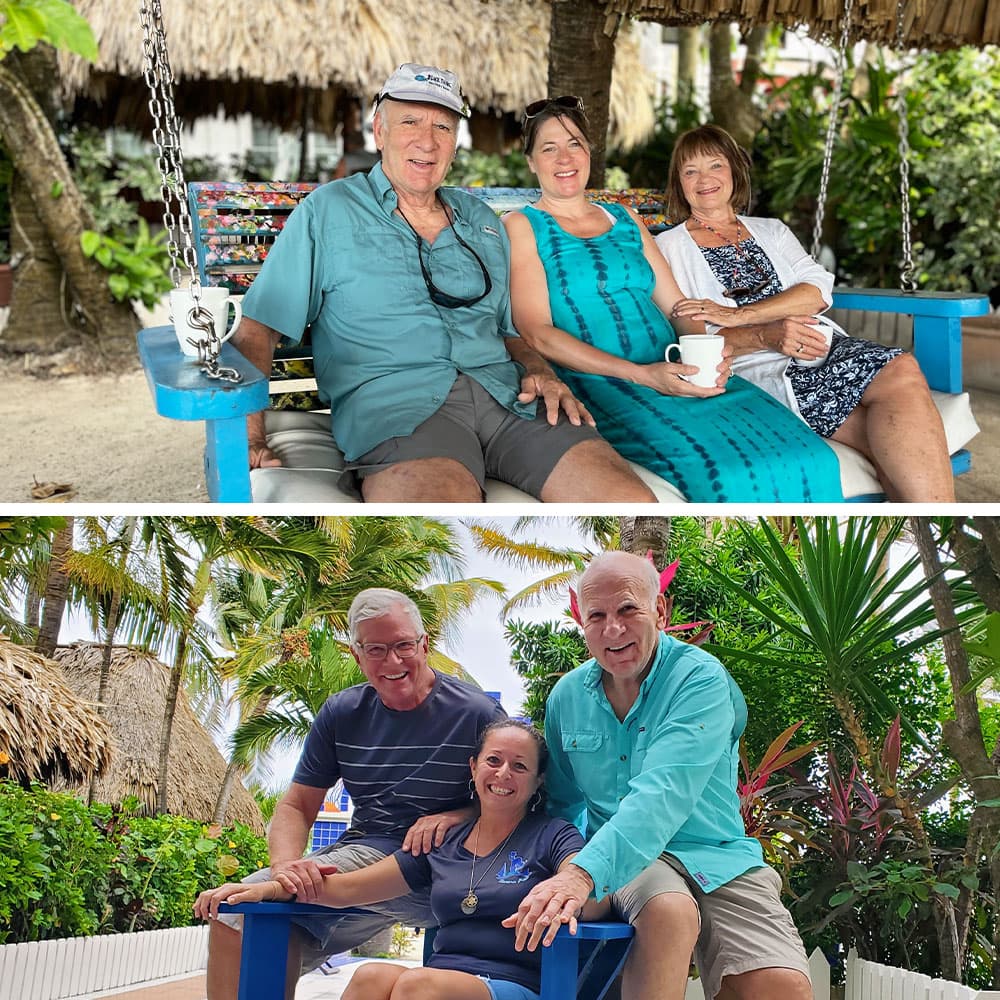 Two groups of people relax on colorful benches under palm trees, enjoying their time together in a tropical setting.