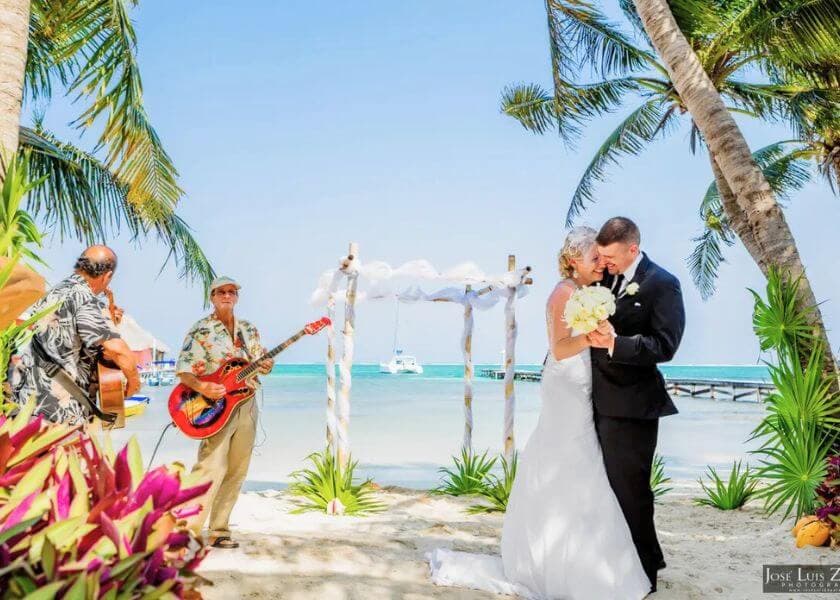bride and groom laughing and walking embracing in belize bride and groom laughing and walking embracing in belize