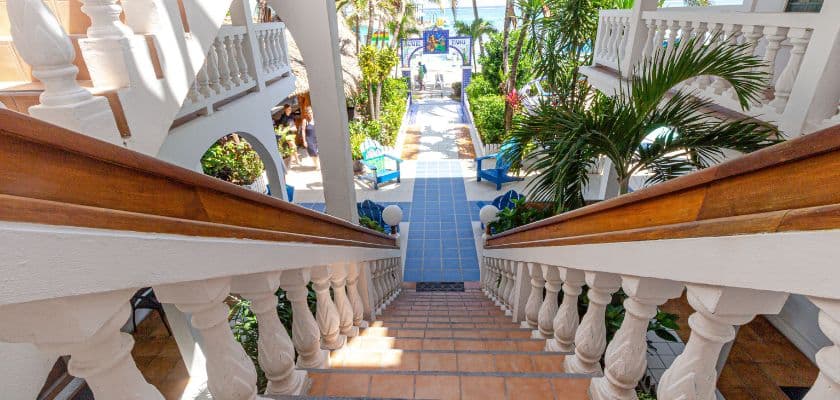 View down the tiled staircase at Blue Tang Inn overlooking the courtyard and beach path.