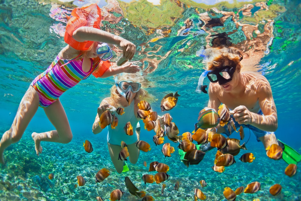 Family snorkeling together - one of the reasons Belize is one of the Best Caribbean Destinations for Families