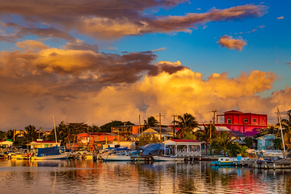 Learn how to get to Ambergris caye so you can enjoy a beautiful sunset over San Pedro Town like this
