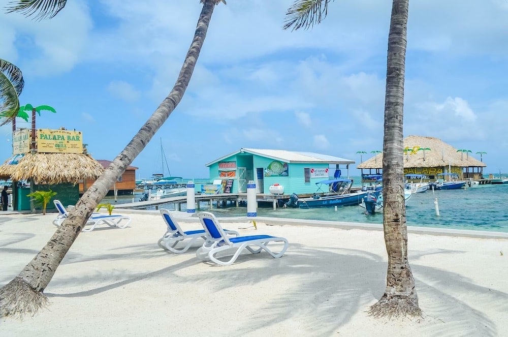 Chairs and the Talapa bar in front of our beachfront Ambergris Caye Resort